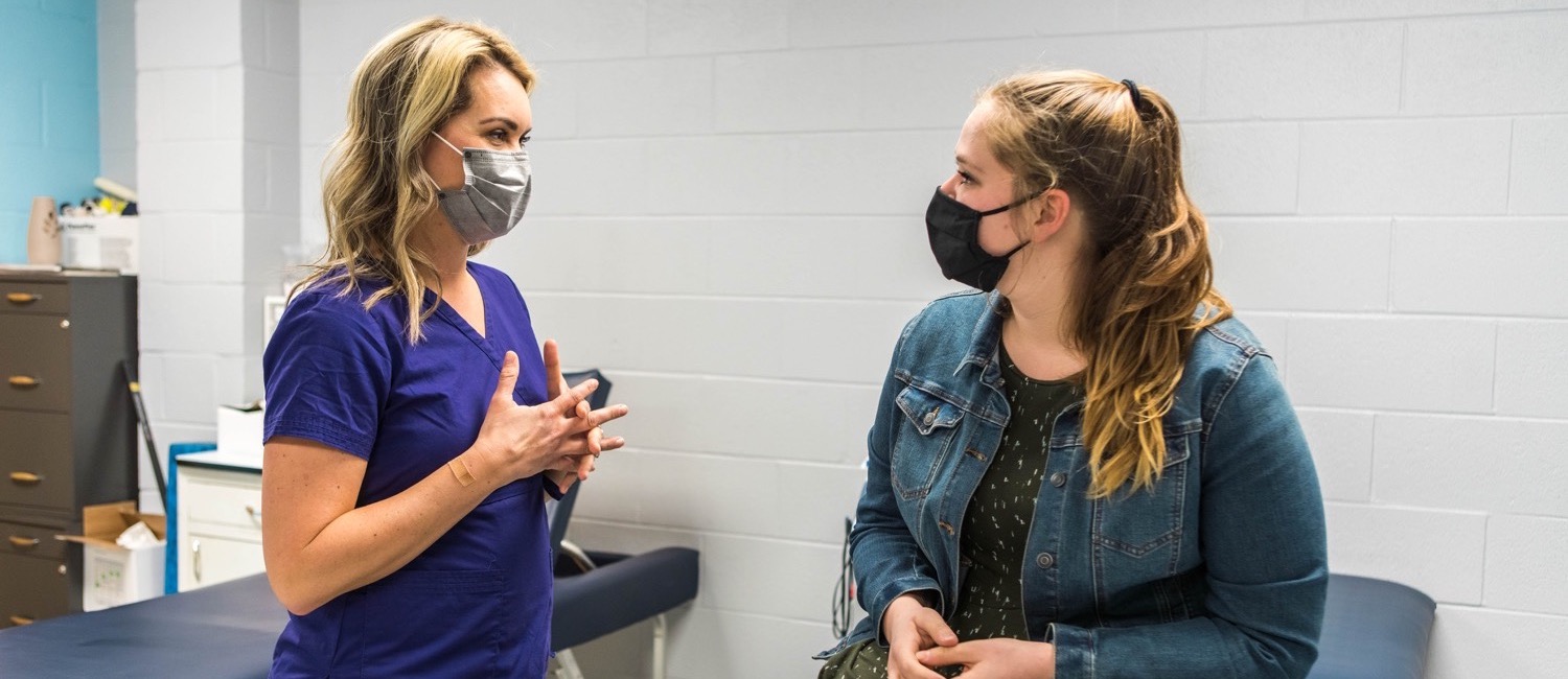 Campus nurse consulting with student